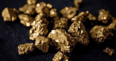 Image of gold nuggets on a black background.